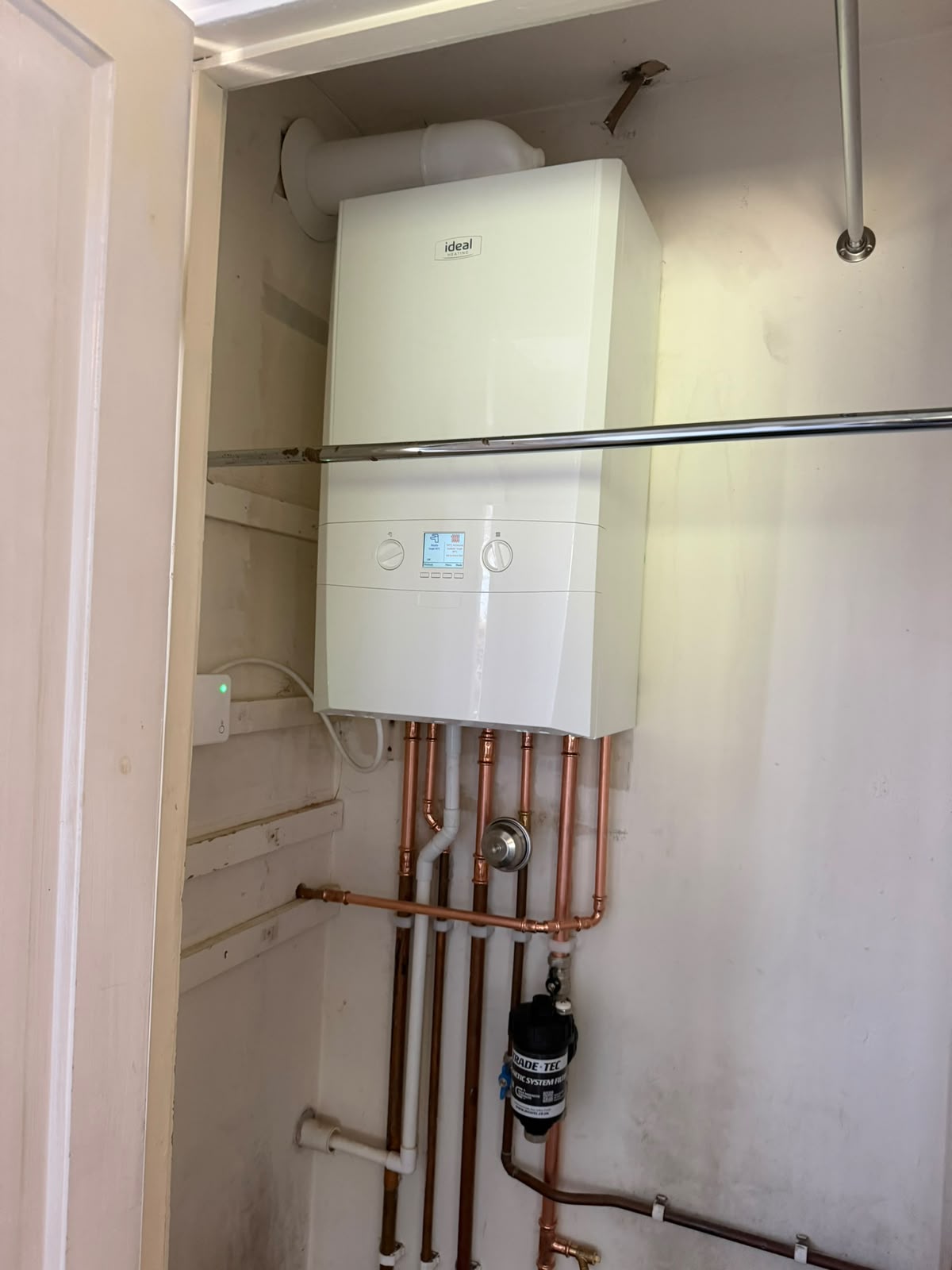 Neatly installed Ideal boiler with copper pipework