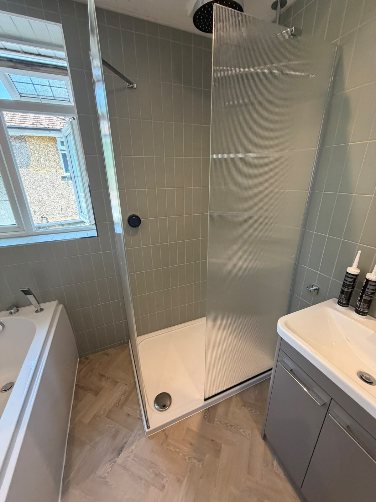 Walk-in shower installation with fluted glass screen