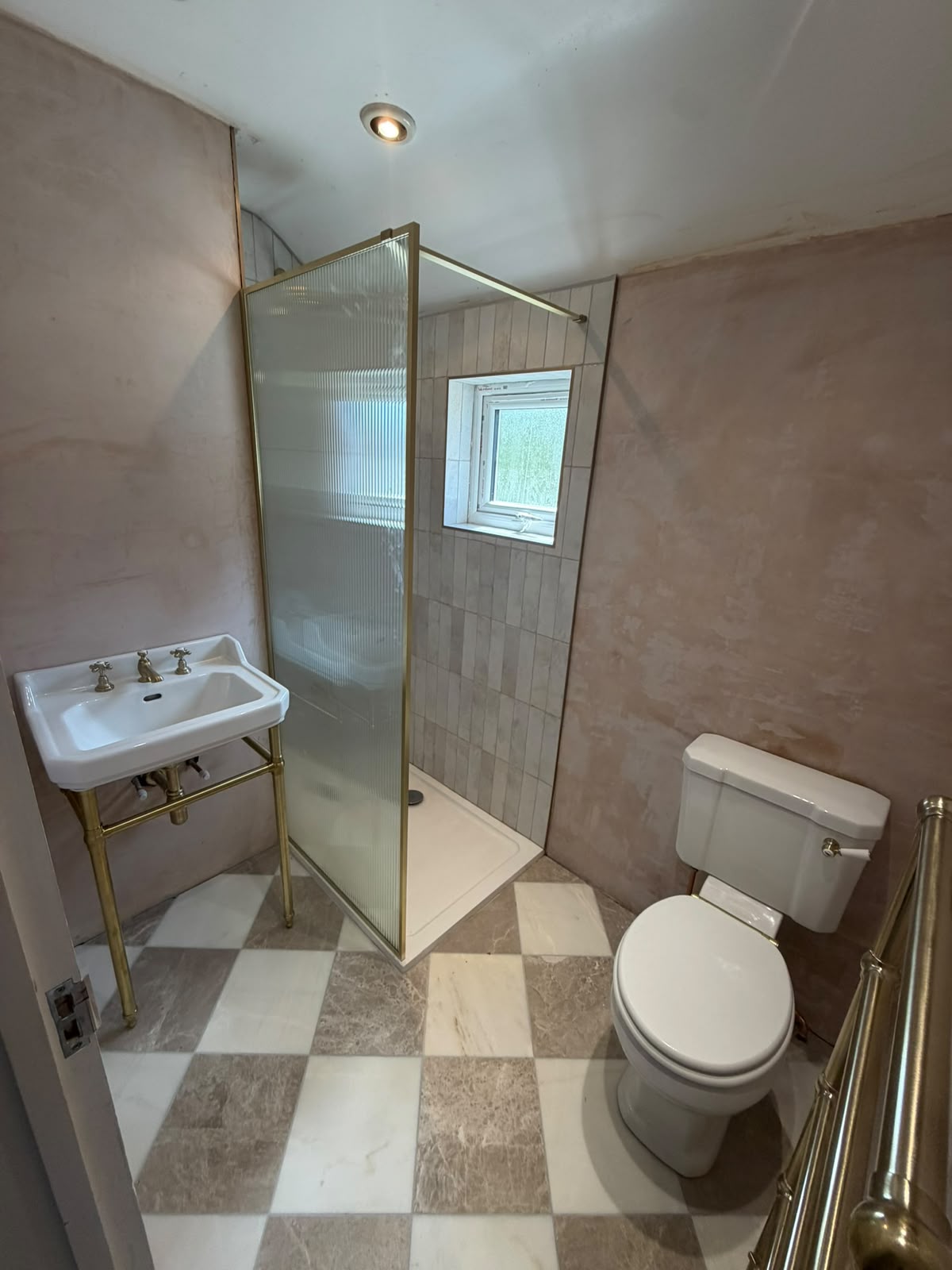 Bathroom with brass shower screen and chequerboard floor